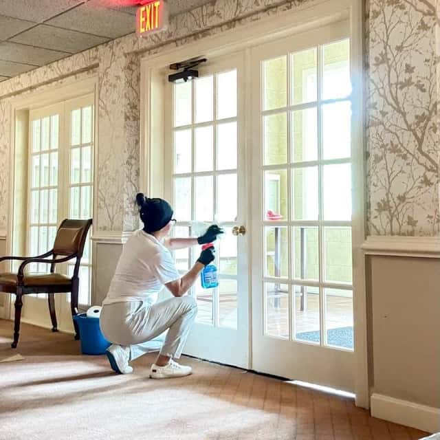 Cleaning the sill of a patio door in a carpeted lounge — MARTS-R.P Cleaning Solutions LLC