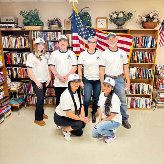 The MARTS-R.P crew posing in front of library shelves — MARTS-R.P Cleaning Solutions LLC